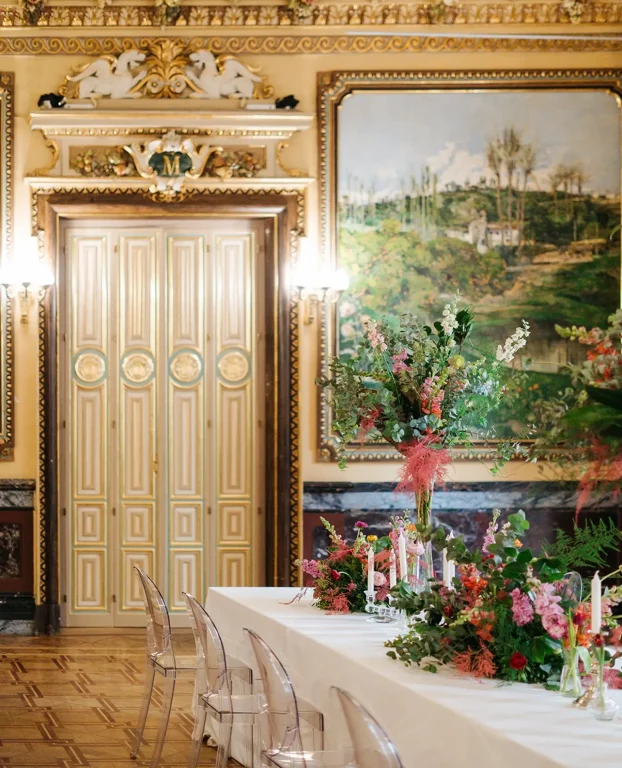 Ambientación floral para reunión corporativa con mesa de dirección y flores decorativas